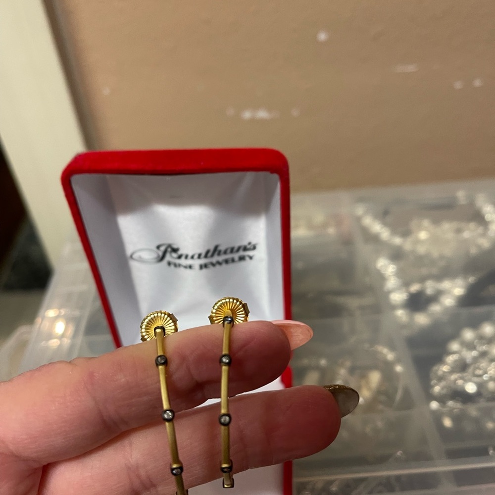 Freida Rothman gold and black earrings.